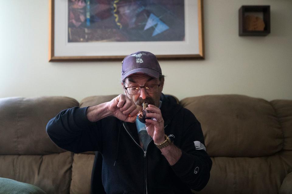 Michael Wirtschafter smokes medically prescribed marijuana in his home in Bear Del. Thursday, may 5, 2022. Wirtschafter has found relief in cannabis over trials with opioids. 