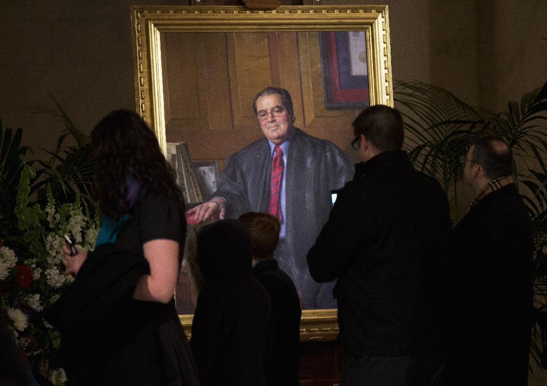 A portrait of Justice Antonin Scalia is displayed near his casket on Feb. 19 in the Great Hall of the Supreme Court in Washington, where his body lay in repose. (Photo: Manuel Balce Ceneta/AP)