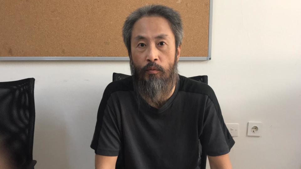 In this image released by the Hatay governorate in Turkey, Jumpei Yasuda of Japan, talks in Antakya, Turkey, Wednesday, Oct. 24, 2018. Japan confirmed Wednesday that a man freed from Syria is the Japanese freelance journalist Yusuda, who was kidnapped three years ago by al-Qaida's branch in Syria, known at the time as the Nusra Front, and said he appears to be in good health. (Antakya Governorate via AP)