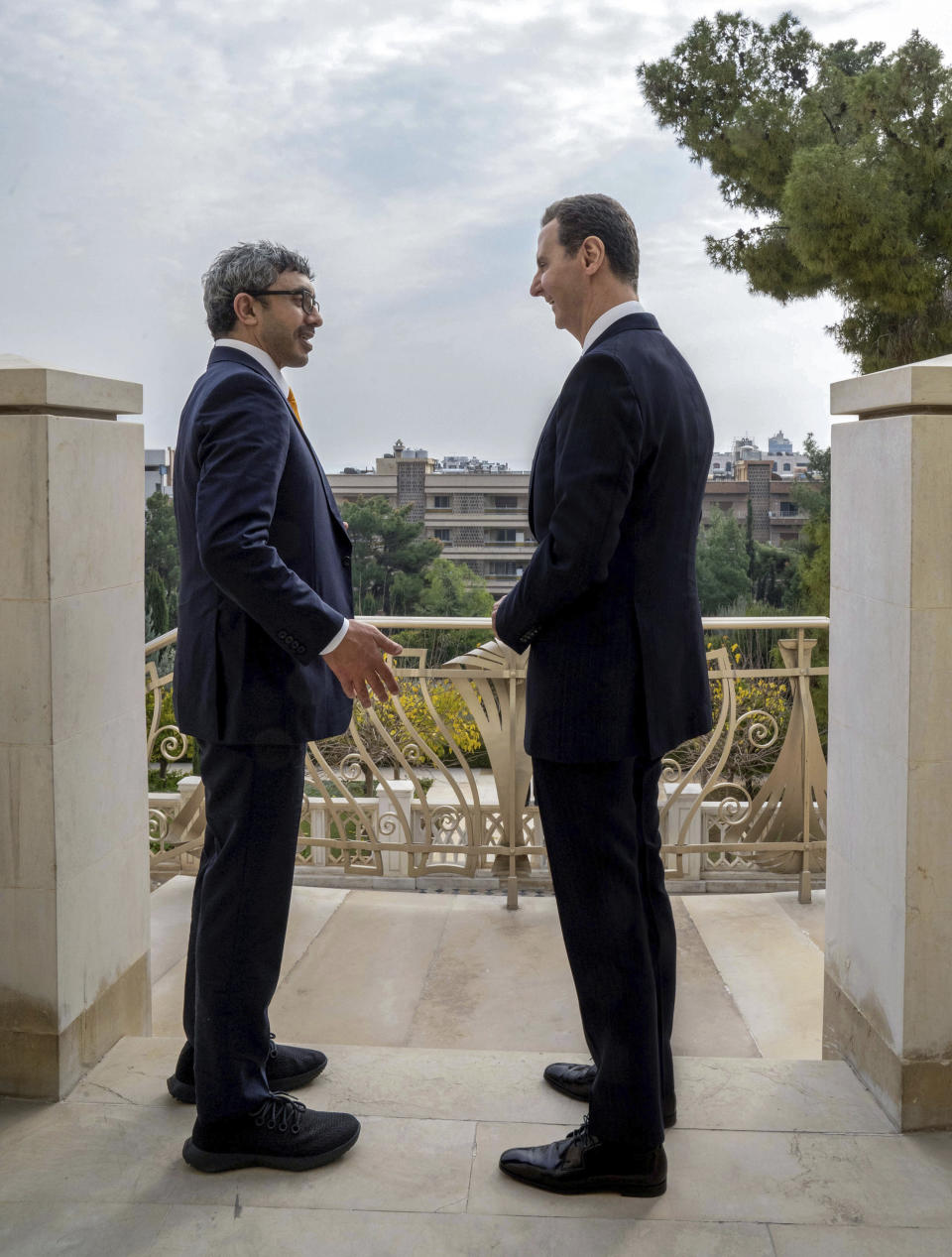 In this photo released by the official Syrian state news agency SANA, Syrian President Bashar Assad, right, speaks with United Arab Emirates Foreign Minister Sheikh Abdullah bin Zayed bin Sultan al-Nahyan in Damascus, Syria, Wednesday, Jan. 4, 2023. Sheikh Abdullah bin Zayed Al Nahyan and Assad discussed boosting economic ties between the two countries, according to a statement from Assad's office. (SANA via AP)