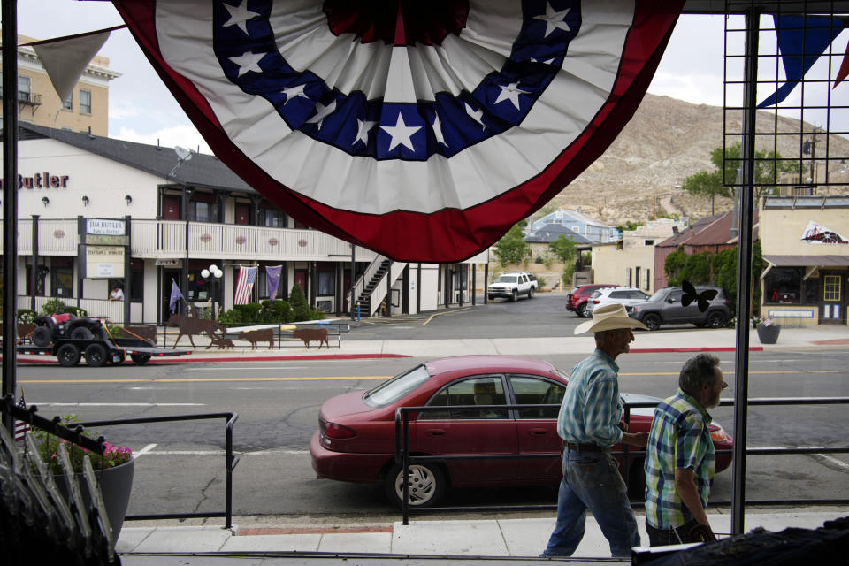 FILE - People walk along the main drag in the county seat of Nye county, Monday, July 18, 2022, in Tonopah, Nev. A new clerk was chosen Tuesday, March 19, 2024, to oversee elections in the deep-red rural Nevada county that has been roiled by false claims of widespread election fraud since 2020. (AP Photo/John Locher, File)