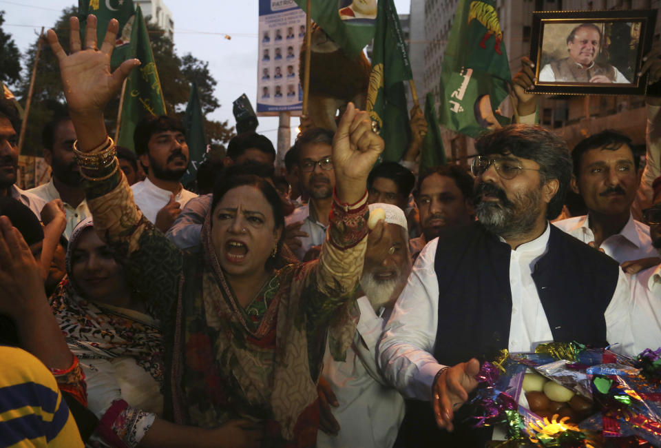 Supporters of Pakistani Prime Minister Nawaz Sharif celebrate the suspension of prison sentences of Sharif, his daughter and son-in-law, in Karachi, Pakistan, Wednesday, Sept. 19, 2018. The Islamabad High Court set them free on bail pending their appeal hearings. The court made the decision on the corruption case handed down to the Sharifs by an anti-graft tribunal earlier this year. (AP Photo/Shakil Adil)