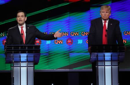 Republican U.S. presidential candidate Marco Rubio speaks as rival Donald Trump (R) listens during the Republican U.S. presidential candidates debate sponsored by CNN at the University of Miami in Miami, Florida March 10, 2016. REUTERS/Carlo Allegri