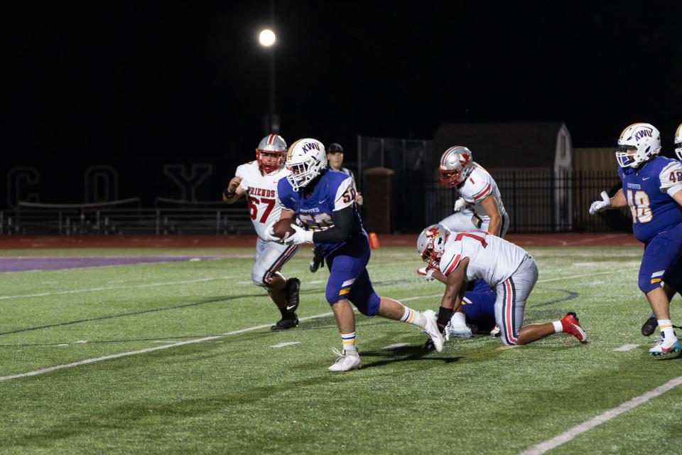 Kansas Wesleyan’s Sloan Simpson (center) returns a fumble late in the fourth quarter of KWU’s 35-28 win over the Friends University Falcons on Saturday night at Gene Bissell Field at JRI Hospitality Stadium and the Graves Family Sports Complex.