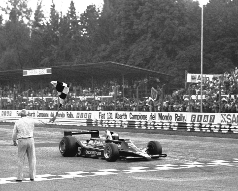 FILE - Mario Andretti gets the checkered flag as he crosses the finish line in the Italian Grand Prix at Monza, Italy, Sept. 10, 1978. Michael and Mario Andretti and the top executives from Andretti Global were at the United States Grand Prix last weekend trying to build support for their bid to launch a Formula One team. The FIA has approved Andretti’s request for expansion but he next must be approved by F1 and its management.(AP Photo/File)