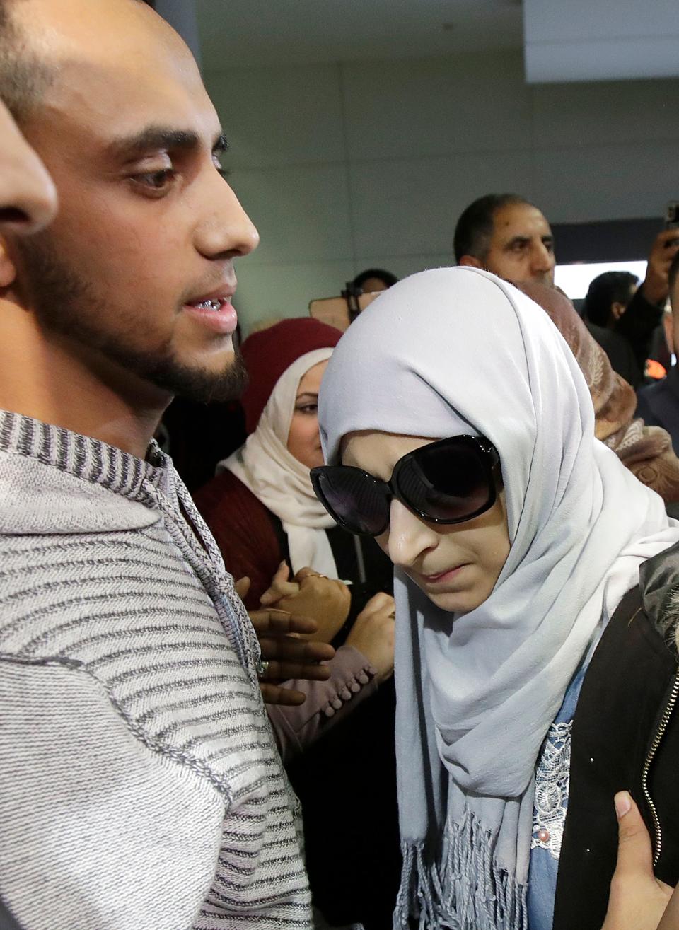 Shaima Swileh, right, stands with her husband Ali Hassan after Swileh arrived at San Francisco International Airport in San Francisco, Wednesday, Dec. 19, 2018. Swileh is the Yemeni mother who won her fight for a waiver from the Trump administration's travel ban that would allow her to go to California to see her dying 2-year-old son.