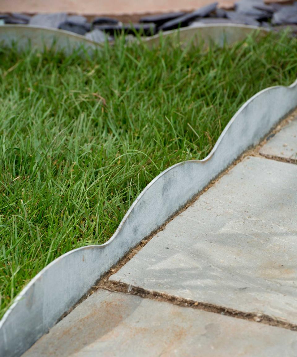4. Divide your patio from the lawn with metal edging