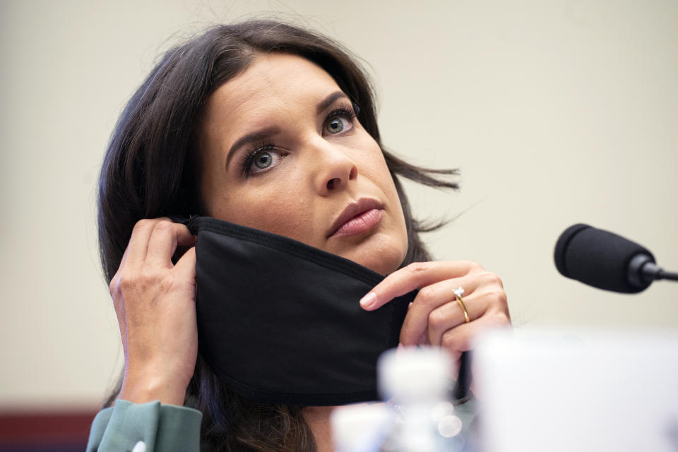 U.S. Correspondent for Seven News Australia Amelia Brace, puts on her mask after making an opening statement, Monday, June 29, 2020, on Capitol Hill in Washington, during the House Natural Resources Committee hearing on the police response in Lafayette Square. (Bonnie Cash/Pool via AP)