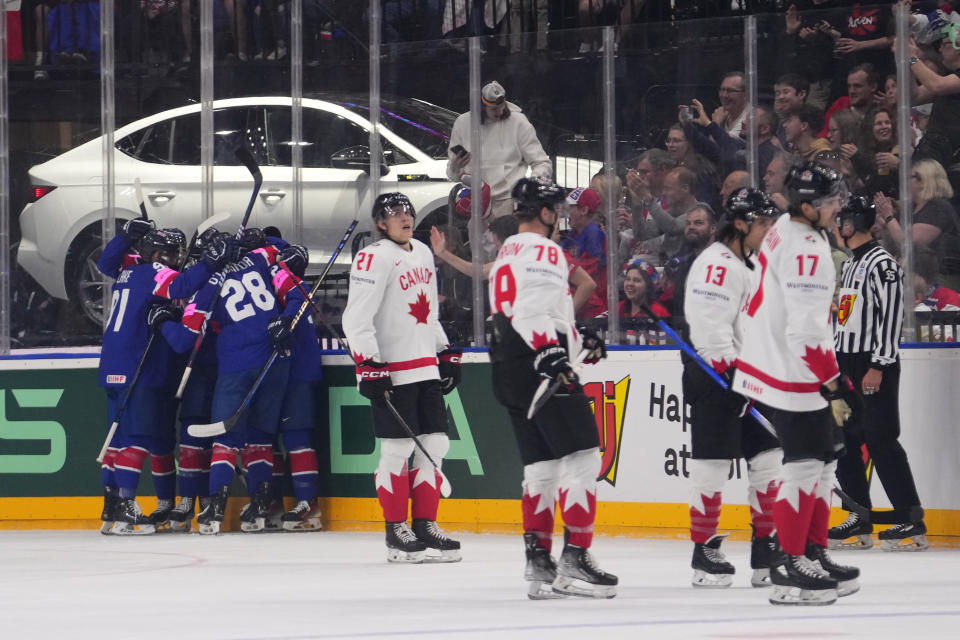 Britain's Liam Kirk celebrates with teammates after scoring his sides first goal during the preliminary round match between Great Britain and Canada at the Ice Hockey World Championships in Prague, Czech Republic, Saturday, May 11, 2024. (AP Photo/Petr David Josek)