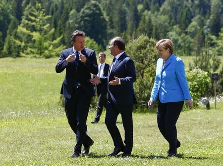 German Chancellor Angela Merkel, French President Francois Hollande and British Prime Minister David Cameron (R-L) walk to attend their first meeting in the hotel castle Elmau in Kruen, Germany, June 7, 2015. REUTERS/Michaela Rehle