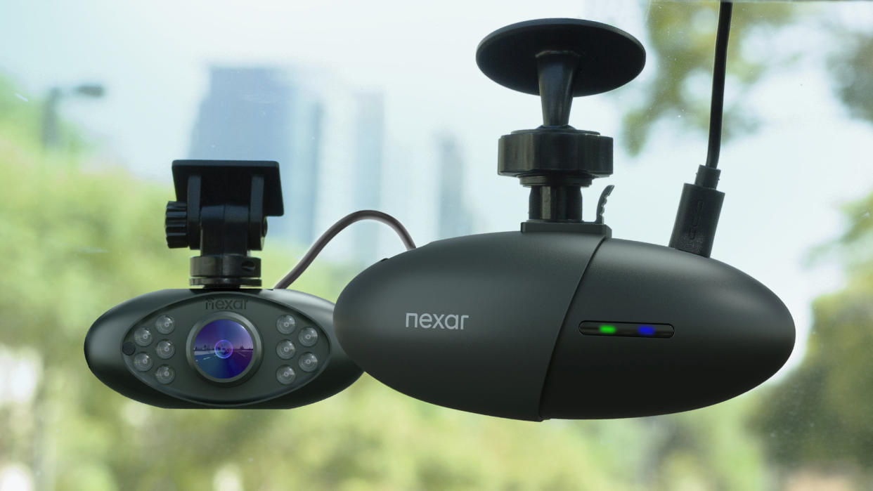  A dash cam mounted inside a car windscreen. 