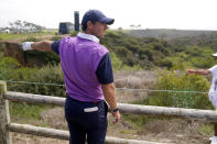 Rory McIlroy, of Northern Ireland, looks for his ball alongside the cart path on the 15th fairway during the third round of the U.S. Open Golf Championship, Saturday, June 19, 2021, at Torrey Pines Golf Course in San Diego. (AP Photo/Jae C. Hong)