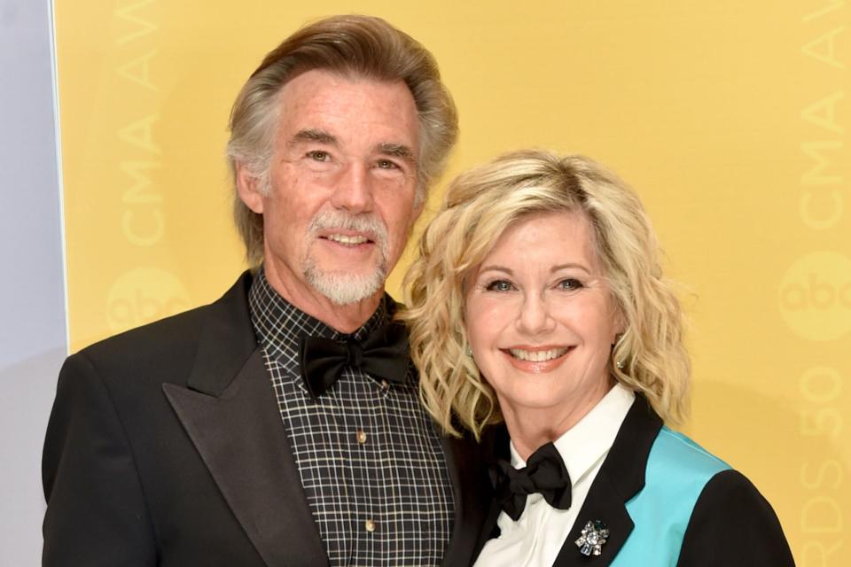 John Easterling (L) and singer Olivia Newton-John (R) attend the 50th annual CMA Awards at the Bridgestone Arena on November 2, 2016 in Nashville, Tennessee