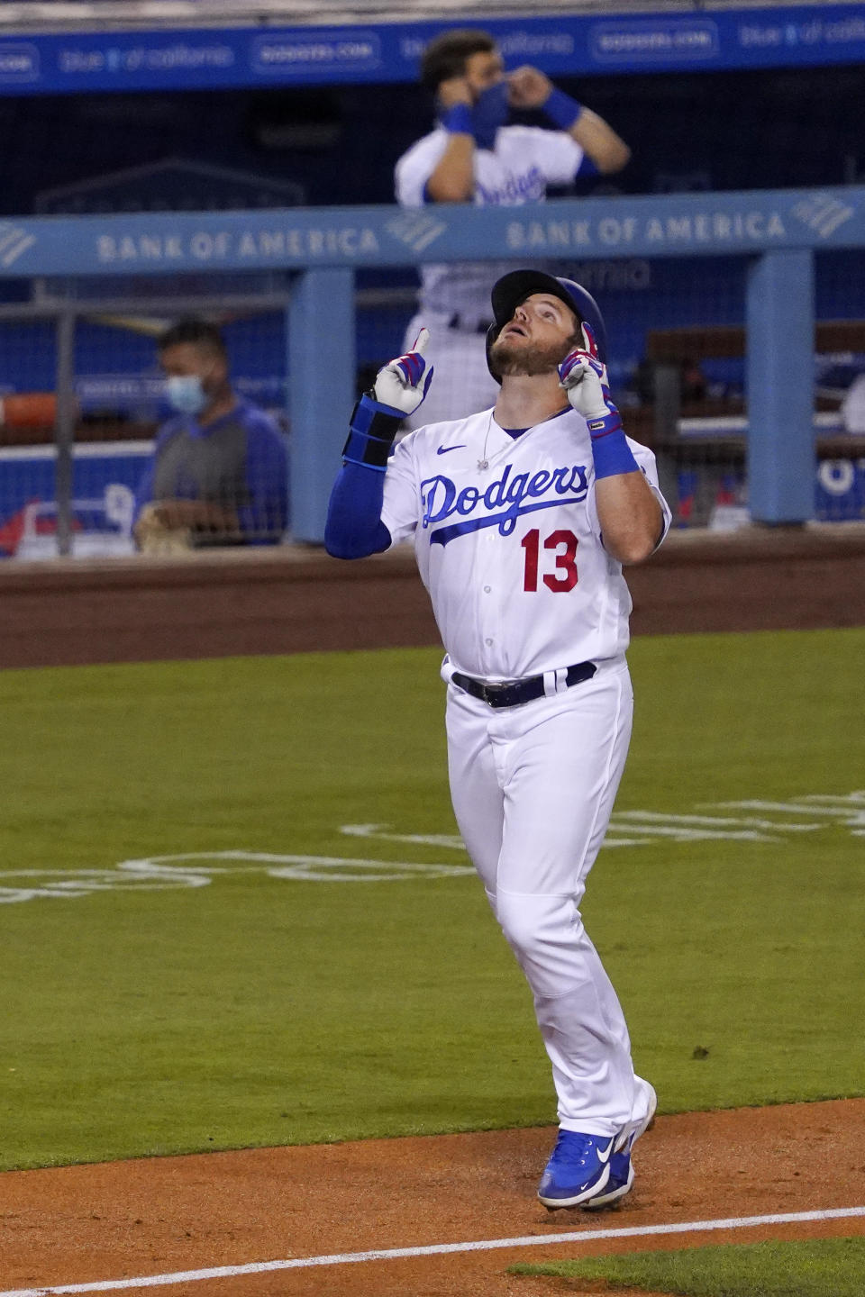 Los Angeles Dodgers' Max Muncy gestures prior to scoring after hitting a solo home run during the fourth inning of a baseball game against the San Francisco Giants Friday, Aug. 7, 2020, in Los Angeles. (AP Photo/Mark J. Terrill)