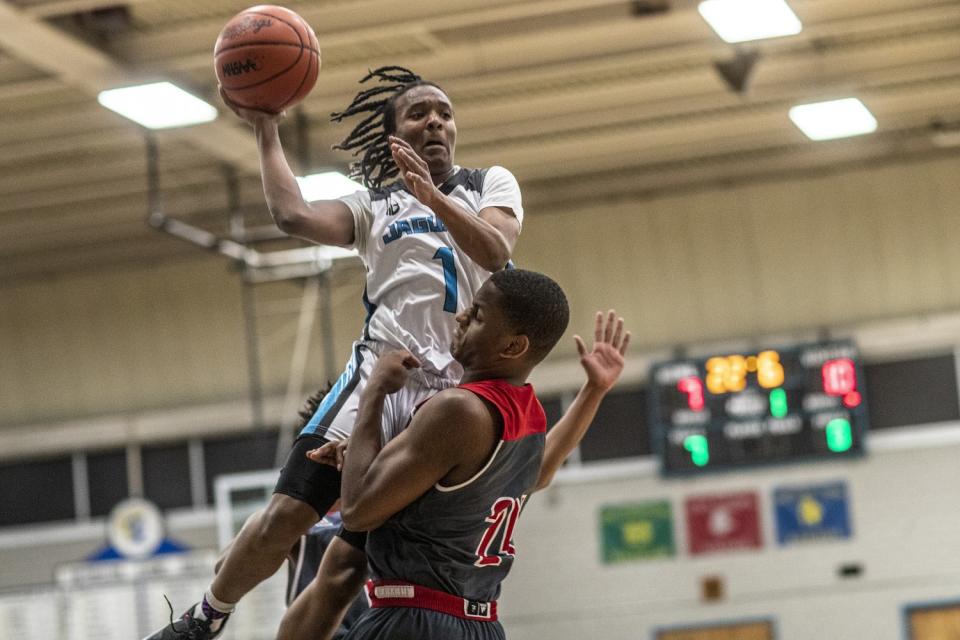 Flint guard Onquay Clemons tries to put up a shot against Beecher.