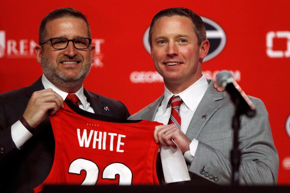 New Georgia basketball coach Mike White poses for a photo with Georgia Director of Athletics Josh Brooks while being introduced as the new men's basketball coach at the University of Georgia in Athens, Ga., on Tuesday, March 15, 2022.