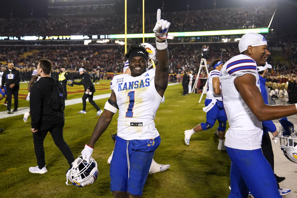 Kansas safety Kenny Logan Jr. (1) celebrates after an NCAA college football game against Iowa State, Saturday, Nov. 4, 2023, in Ames, Iowa. Kansas won 28-21. (AP Photo/Charlie Neibergall)