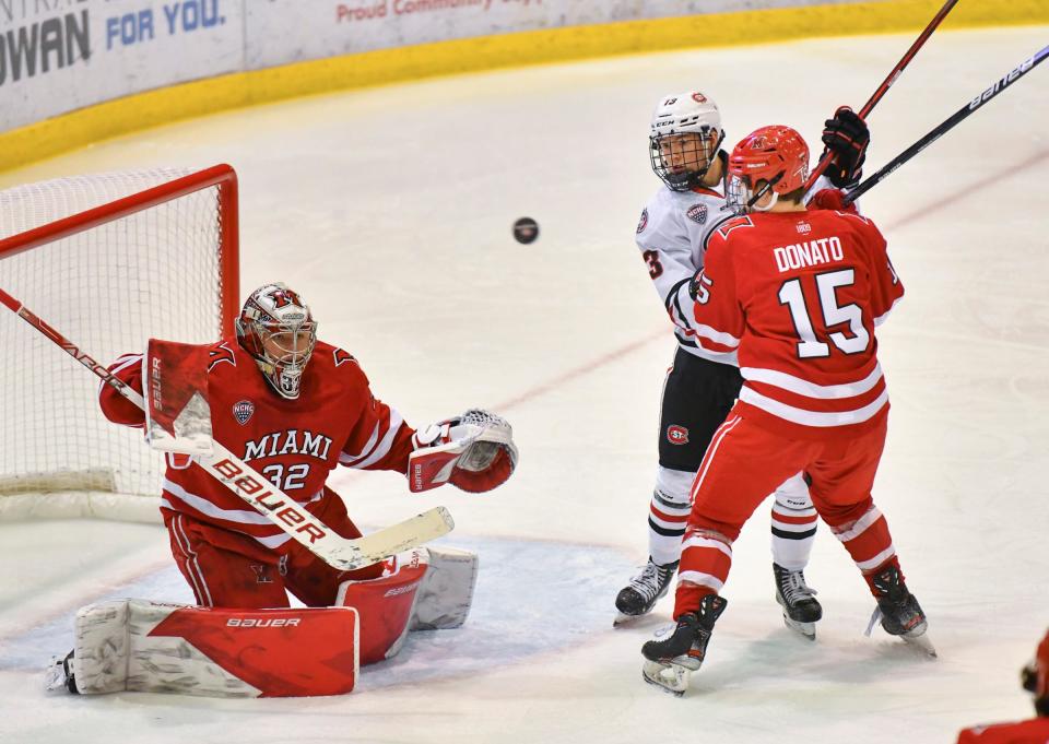 St. Cloud State's Jami Krannila watches as the puck flies past him toward Miami goaltender Ludvig Persson during the first period of the game Friday, Jan. 21, 2022, at The Herb Brooks National Hockey Center in St Cloud.