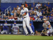 Miami Marlins' Nick Fortes, left, watches his walkoff solo home run during the ninth inning of a baseball game against the New York Mets, Sunday, June 26, 2022, in Miami. (David Santiago/Miami Herald via AP)