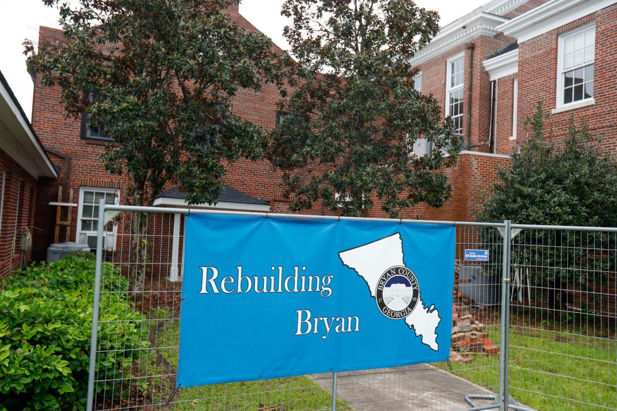 A "Rebuilding Bryan" banner hangs from the fencing around the Bryan County Courthouse in Pembroke. The photograph was taken in April 2023, one year after the tornado hit the northern end of the county.