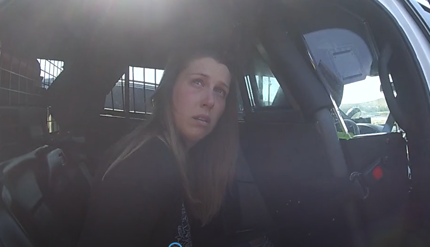 In this video image from an officer's body camera, Shanna Gardner peers up at an officer as he asks her some questions and advises her what's happening during her arrest in Benton County, Wash., on Aug. 17 in her ex-husband Jared Bridegan's murder plot in Jacksonville Beach.