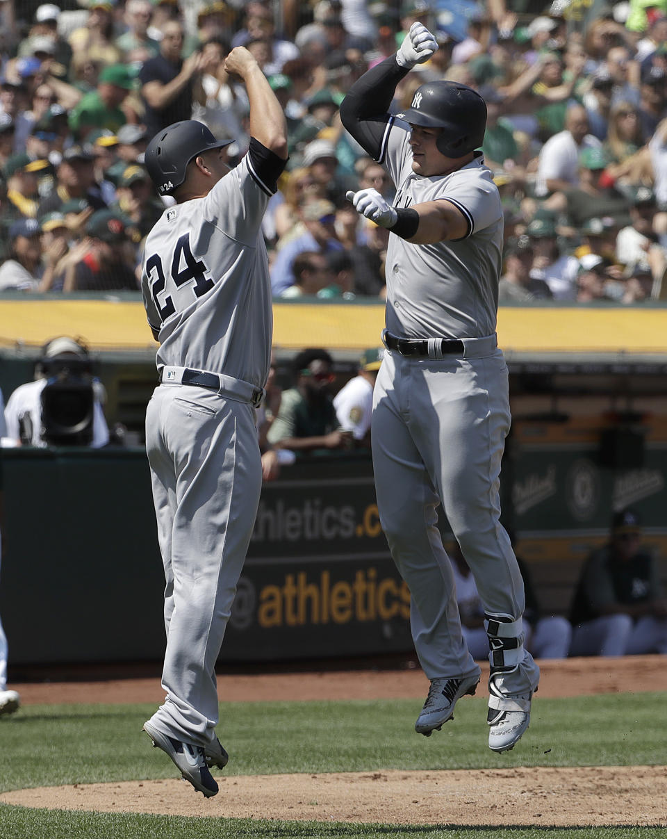 New York Yankees' Luke Voit, right, celebrates after hitting a two-run home run that scored Gary Sanchez (24) during the second inning of a baseball game in Oakland, Calif., Monday, Sept. 3, 2018. (AP Photo/Jeff Chiu)