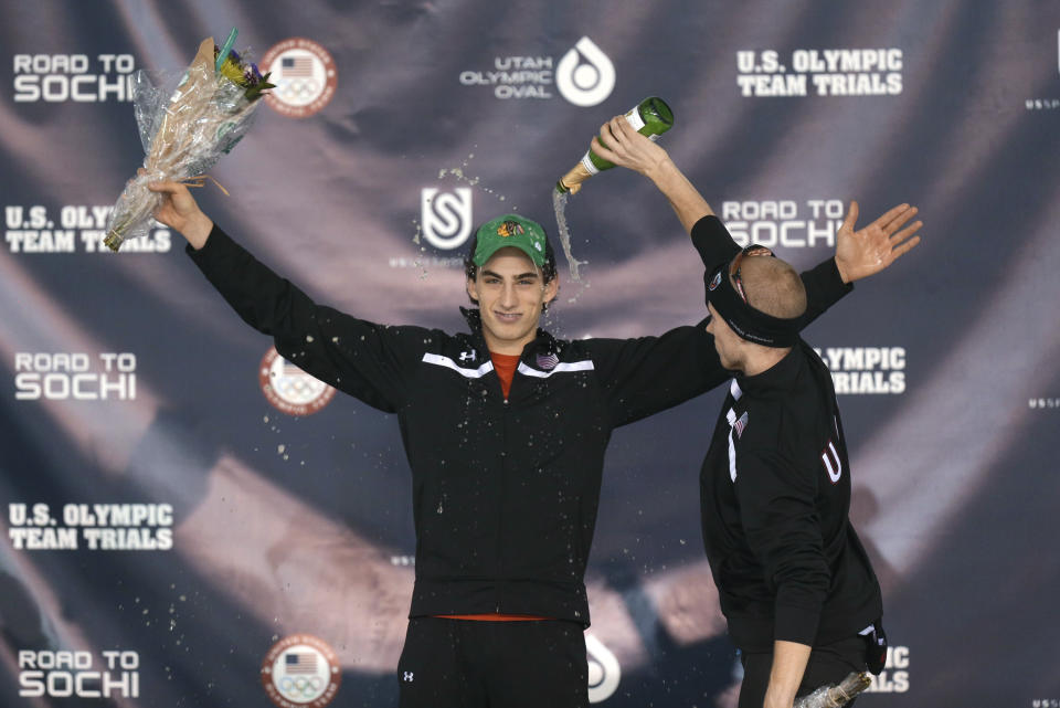 Winner Emery Lehman, left, celebrates with third-place finisher Patrick Meek, right, on the podium following the men's 10,000 meters during the U.S. Olympic speedskating trials Wednesday, Jan. 1, 2014, in Kearns, Utah. (AP Photo/Rick Bowmer)