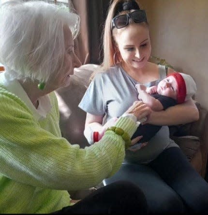 Kathy Castro, left, visits with her niece Taylor and her great-nephew Julian in 2023.