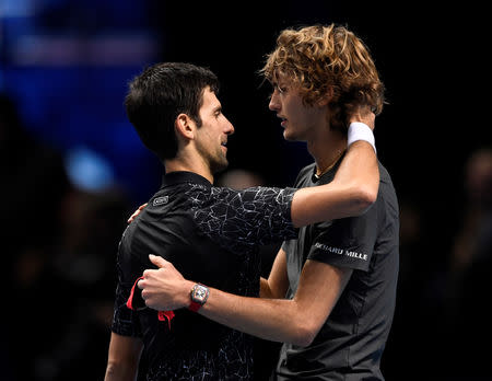 Tennis - ATP Finals - The O2, London, Britain - November 18, 2018 Germany's Alexander Zverev hugs Serbia's Novak Djokovic as he celebrates winning the final Action Images via Reuters/Tony O'Brien