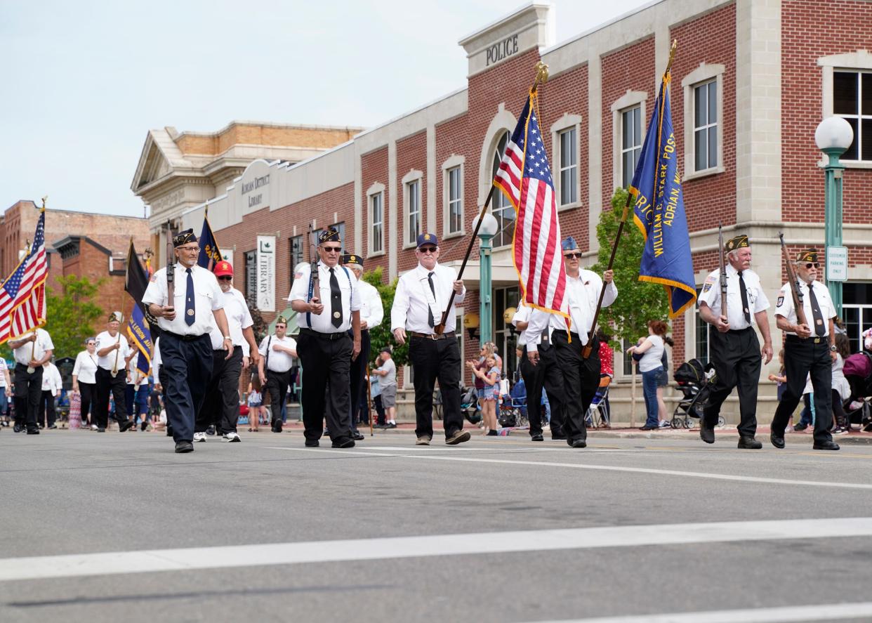 Honor guard members lead the Memorial Day parade through downtown Adrian May 31, 2021.