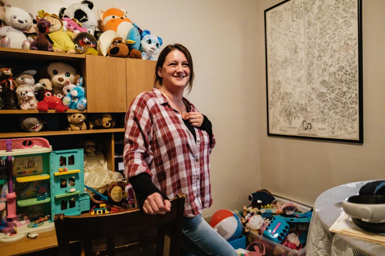 Heather Pereces talks about a family tree from her father's side, at right, in her Uhrichsville home.