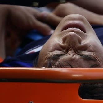 Kensuke Nagai grimaces in pain after being injured while scoring in Japan's 3-0 win over Egypt in the men's soccer quarter-finals.(AP Photo)