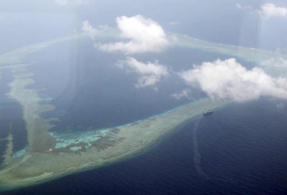 In this photo provided by the Armed Forces of the Philippines, the Philippine Navy ship BRP Gregorio del Pilar is seen (center right) after it ran aground during a routine patrol Wednesday, Aug. 29, 2018, in the vicinity of Half Moon Shoal, which is called Hasa Hasa in the Philippines, off the disputed Spratlys Group of islands in the South China Sea, adding that its crew was unhurt, the military said. Two officials say Friday, Aug. 31, 2018, the Philippines has notified China about a Philippine navy frigate that ran aground in the South China Sea to avoid any misunderstanding because the incident happened near a hotly disputed region. The barren shoal is on the eastern edge of the disputed Spratly archipelago. (Armed Forces of the Philippines via AP)