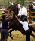 <p>Stablemen and security agents try to stop a horse named Cihan from throwing<br> off Turkey’s Prime Minister Tayyip Erdogan during the opening of a<br> sightseeing park in Istanbul July 30, 2003. Prime Minister fell but escaped<br> unhurt from the incident. (Anatolian/Reuters) </p>
