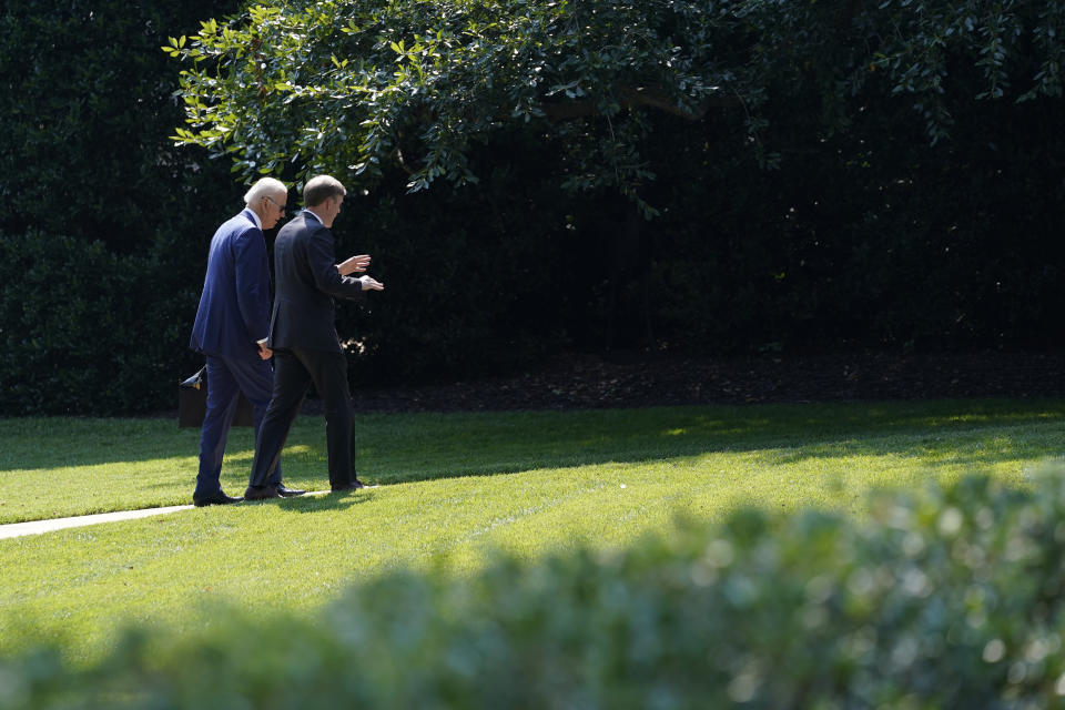 President Joe Biden, left, walks back to the Oval Office with National Security Adviser Jake Sullivan, right, at the White House in Washington, Tuesday, July 27, 2021. They were returning from a visit to the Office of the Director of National Intelligence in McLean, Virginia. (AP Photo/Susan Walsh)