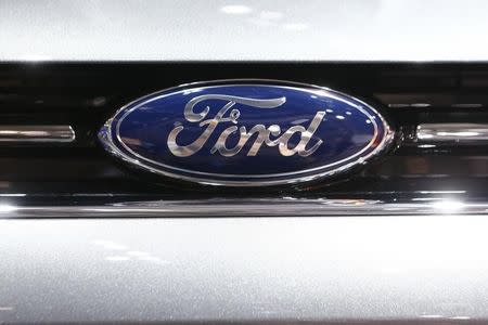 The company logo is seen on the bonnet of a Ford car during the media day ahead of the 84th Geneva Motor Show at the Palexpo Arena in Geneva March 5, 2014. REUTERS/Arnd Wiegmann