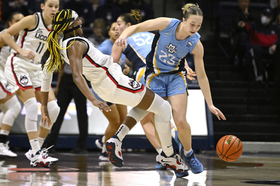 Marquette's Jordan King, right, fouls Connecticut's Aaliyah Edwards, left, in the first half of an NCAA college basketball game, Saturday, Dec. 31, 2022, in Storrs, Conn. (AP Photo/Jessica Hill)