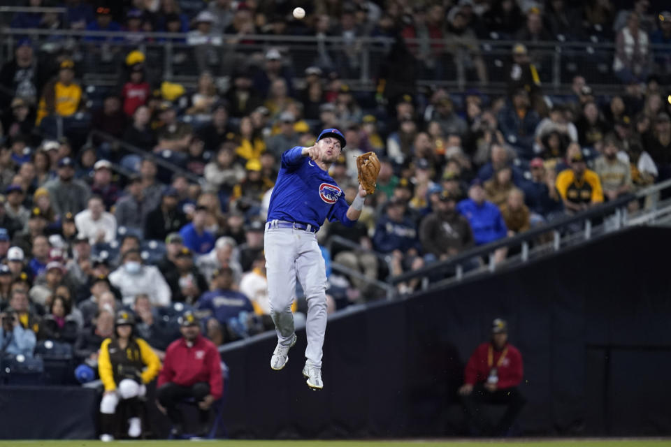 Chicago Cubs shortstop Nico Hoerner makes a leaping throw to first for the out on San Diego Padres' Manny Machado during the fourth inning of a baseball game Tuesday, May 10, 2022, in San Diego. (AP Photo/Gregory Bull)