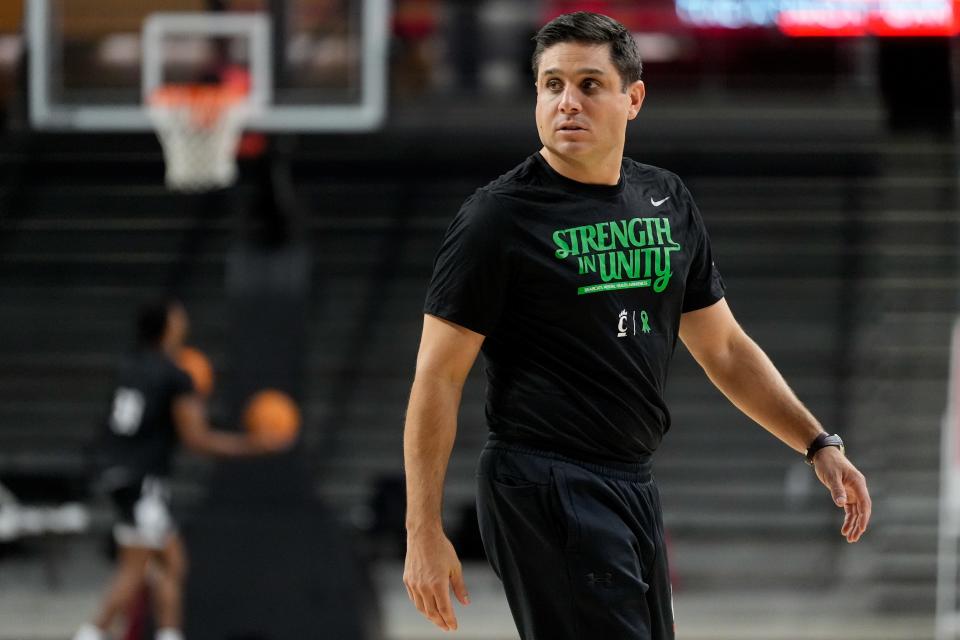 Cincinnati Bearcats head coach Wes Miller joins warmups during a preseason practice at Fifth Third Arena in Cincinnati on Tuesday, Oct. 3, 2023.