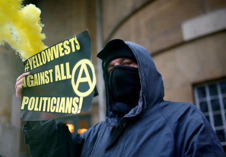 FILE PHOTO: A man holds a banner as he shows his support for a yellow vest movement in Britain, before an anti-Brexit demonstration march in central London, Britain January 12, 2019. REUTERS/Henry Nicholls/File Photo