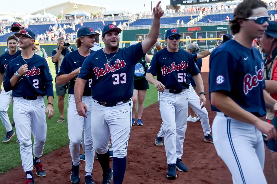 Jun 23, 2022; Omaha, NE, USA;  Ole Miss Rebels infielder Ben Van Cleve (33) waves to the fans after the victory against the Arkansas Razorbacks to advance to the final series of the College World Series at Charles Schwab Field. Mandatory Credit: Steven Branscombe-USA TODAY Sports