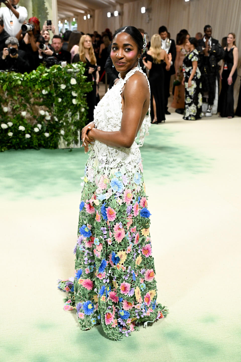 Ayo Edebiri at the 2024 Met Gala wearing a floor-length dress with flowers