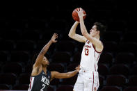 Southern California guard Drew Peterson (13) shoots over Washington State guard Myles Warren (2) during the second half of an NCAA college basketball game Saturday, Jan. 16, 2021, in Los Angeles. (AP Photo/Ringo H.W. Chiu)