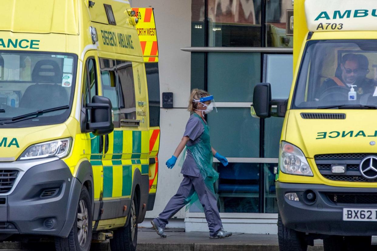 Hospital staff and ambulance staff prepare to take a patient into the Royal Liverpool University Hospital: PA