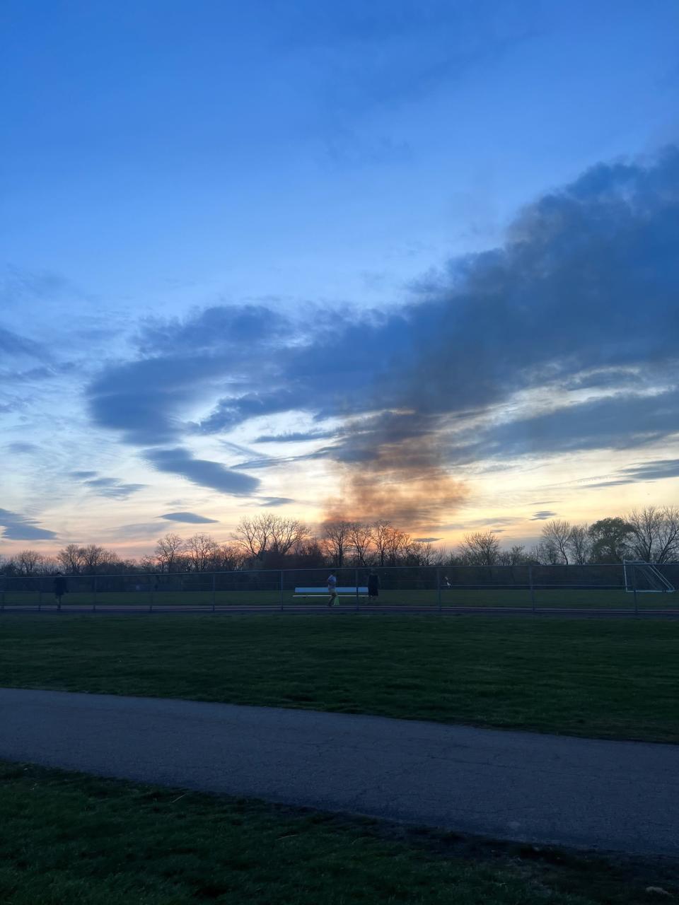 Smoke can be seen rising to the sky around 7:30 p.m. from Overpeck Park on Tuesday, April 12, 2023.