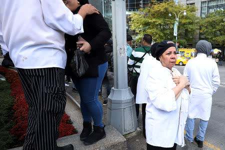 Evacuees are pictured outside the Time Warner Center in the Manahattan borough of New York City after a suspicious package was found inside the CNN Headquarters in New York, U.S., October 24, 2018. REUTERS/Kevin Coombs