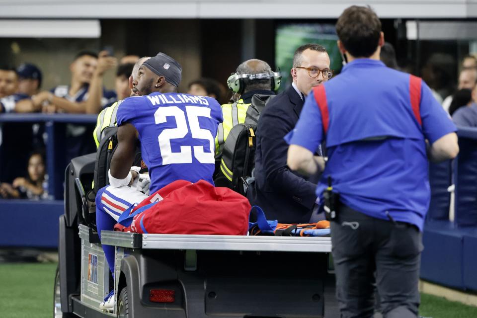 New York Giants cornerback Rodarius Williams (25) is carted off the field after suffering an unknown in injury in the second half of an NFL football game against the Dallas Cowboys in Arlington, Texas, Sunday, Oct. 10, 2021. (AP Photo/Michael Ainsworth)