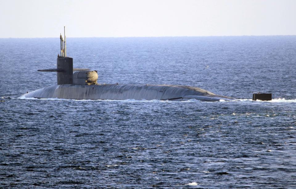 In this photo made available by the U.S. Navy, the guided-missile submarine USS Georgia transits the Strait of Hormuz in Persian Gulf, Monday, Dec. 21, 2020. The USS Georgia traversed the strategically vital waterway between Iran and the Arabian Peninsula on Monday, the U.S. Navy said, a rare announcement that comes amid rising tensions with Iran. (Mass Communication Specialist 2nd Class Indra Beaufort/U.S. Navy via AP)