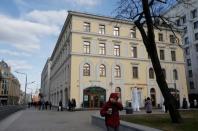 People walk along a street past Vozdvizhenka 9 building 2 in central Moscow, Russia, April 20, 2017. Picture taken April 20, 2017. REUTERS/Maxim Shemetov/Files