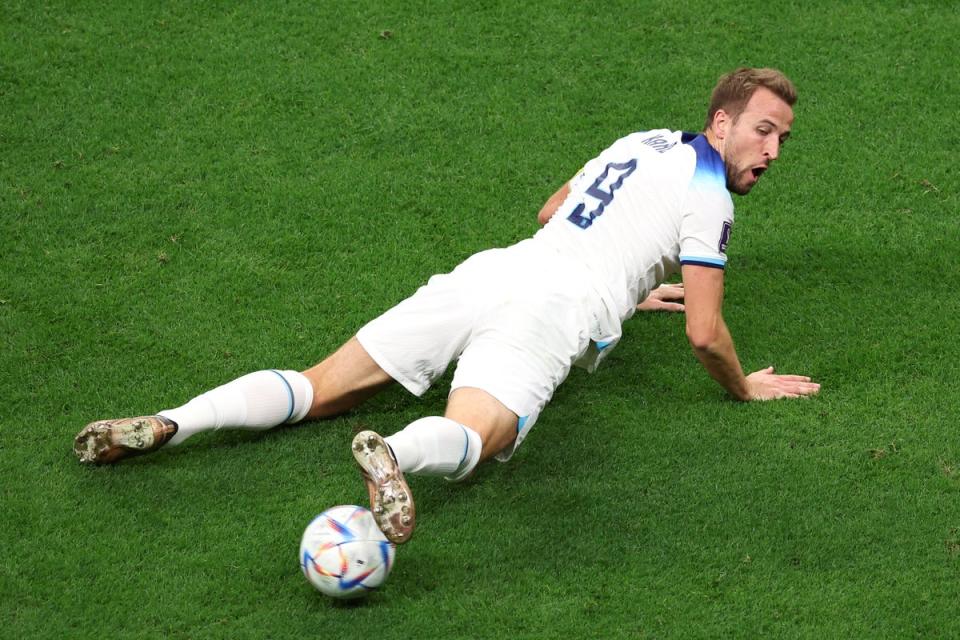 Kane steadies the ball from a prone position (Getty)